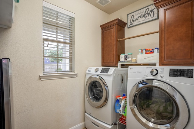 laundry area with cabinets and independent washer and dryer