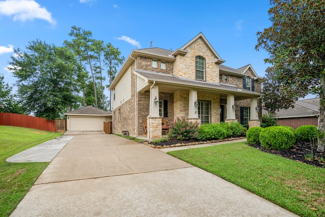 view of front of property with a front lawn, a garage, and covered porch