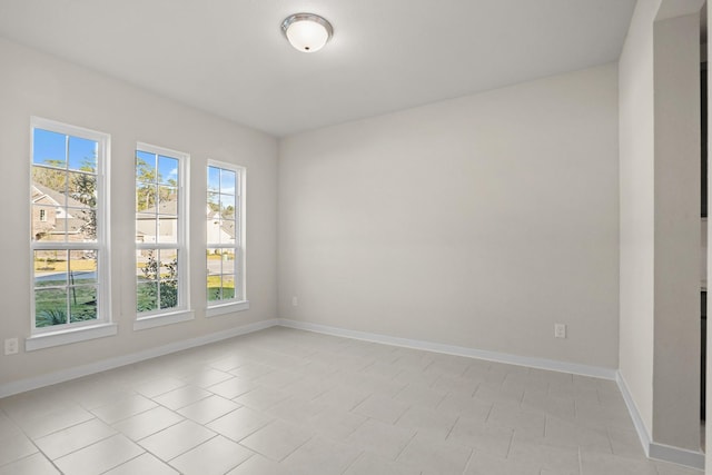 unfurnished room featuring light tile patterned flooring