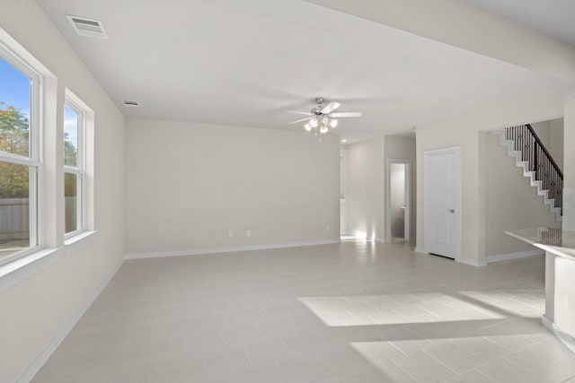 empty room featuring ceiling fan and light tile patterned floors