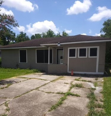 rear view of house with a garage