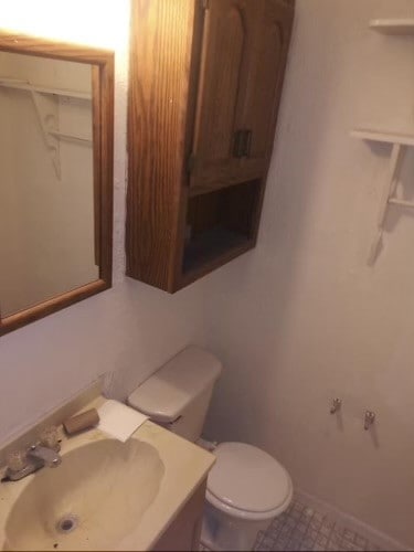 bathroom featuring sink, toilet, and tile patterned floors