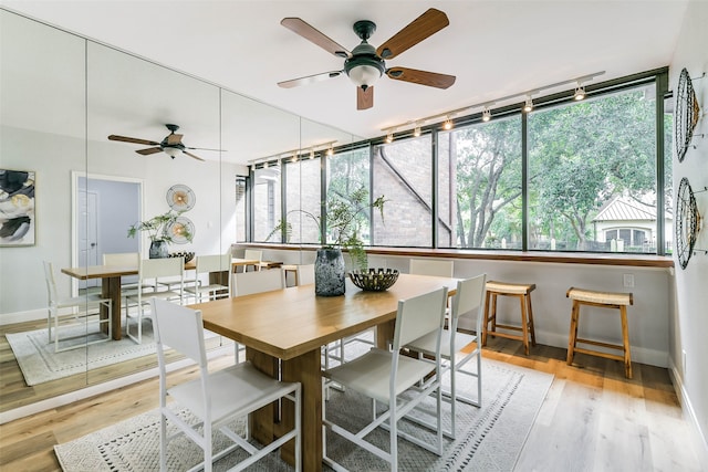 dining room with light hardwood / wood-style floors and ceiling fan