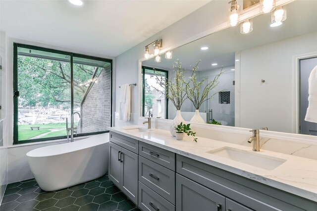 bathroom with dual vanity, tile patterned floors, and a tub