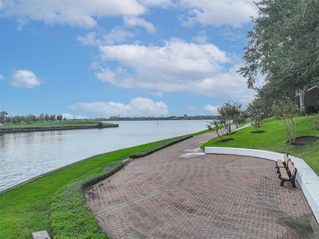 view of home's community featuring a water view and a lawn