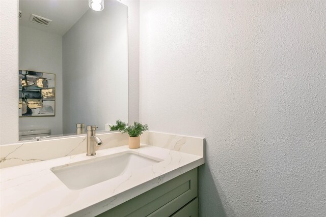 bathroom with toilet and vanity