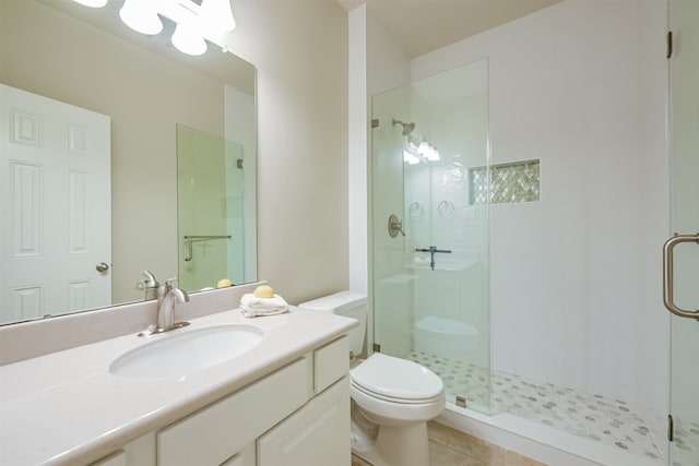 bathroom featuring walk in shower, tile patterned floors, toilet, and vanity