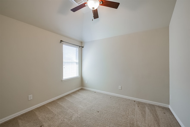 spare room with ceiling fan, light colored carpet, and lofted ceiling