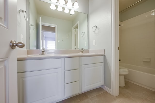 full bathroom with vanity, tiled shower / bath combo, tile patterned floors, and toilet