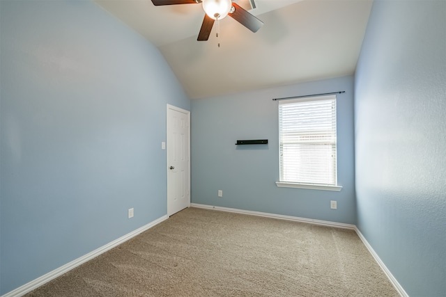 unfurnished room with ceiling fan, lofted ceiling, and carpet