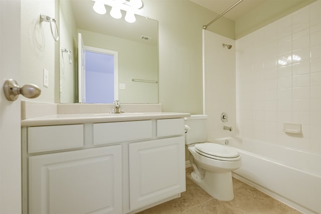 full bathroom featuring vanity, tiled shower / bath, and toilet