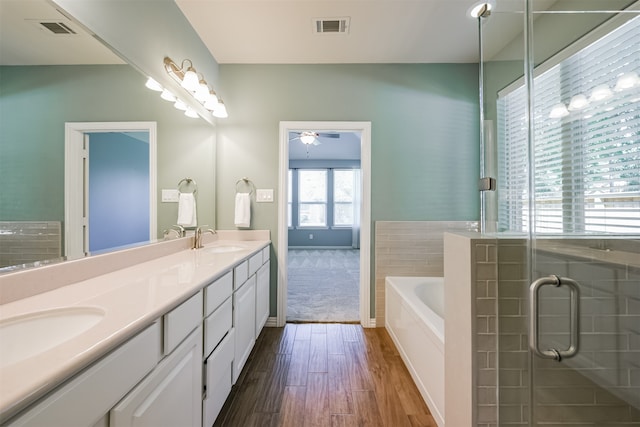 bathroom with vanity, wood-type flooring, ceiling fan, and separate shower and tub