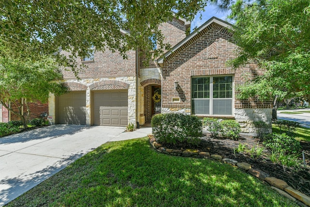 view of front of property with a garage and a front lawn