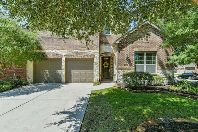 view of front of house featuring a garage and a front lawn