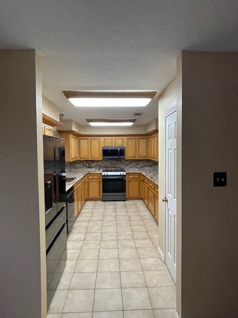 kitchen featuring decorative backsplash, stainless steel appliances, and light tile patterned floors