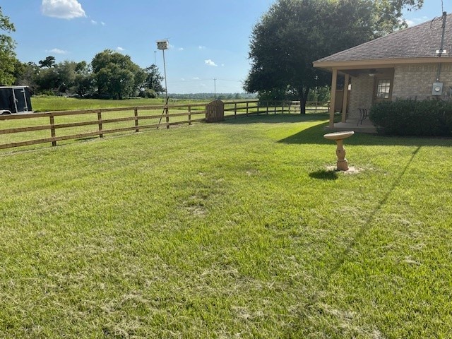 view of yard with a rural view