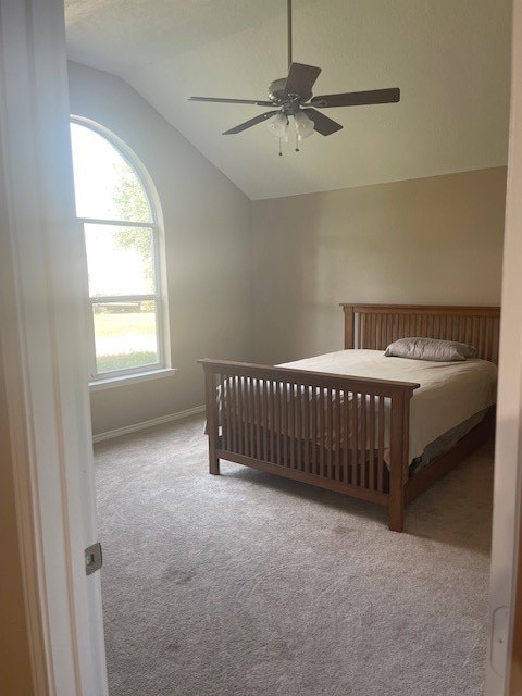 bedroom featuring carpet floors, ceiling fan, and vaulted ceiling