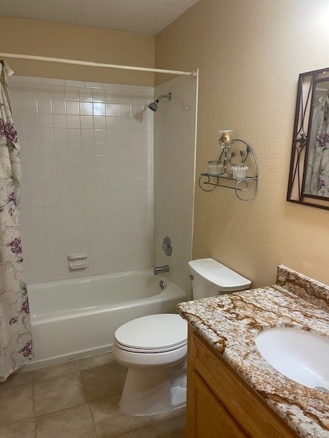 full bathroom featuring tile patterned floors, vanity, shower / tub combo with curtain, and toilet