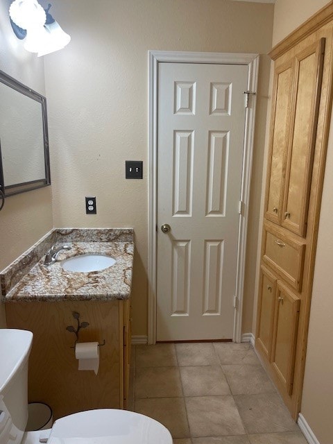 bathroom with vanity, tile patterned floors, and toilet