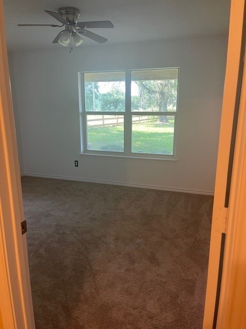 carpeted empty room with plenty of natural light and ceiling fan