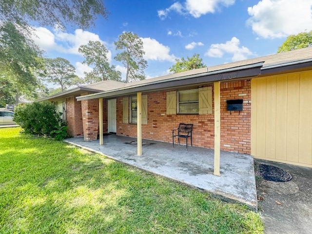 back of house with a lawn