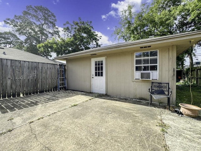 rear view of property with fence and a patio