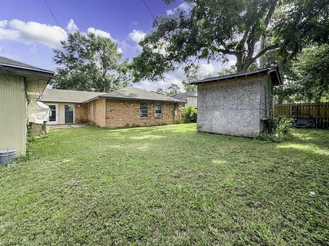 view of yard featuring fence and an outdoor structure