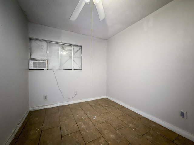 empty room with baseboards, a ceiling fan, and hardwood / wood-style floors