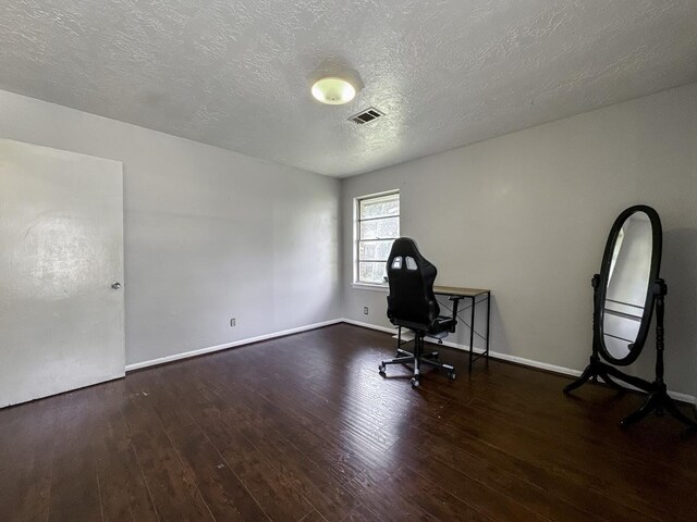 office with hardwood / wood-style floors and a textured ceiling