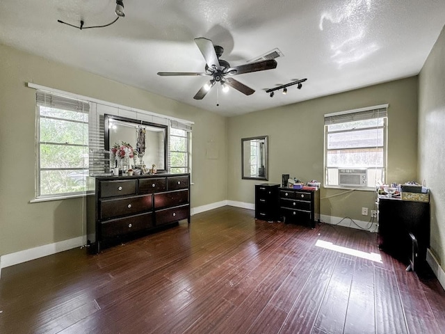 bedroom with cooling unit, wood-type flooring, and baseboards