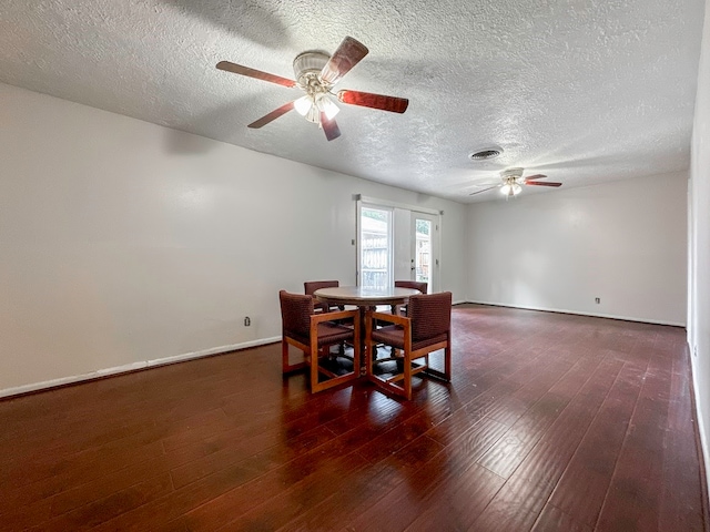 dining area with a textured ceiling, ceiling fan, and hardwood / wood-style floors