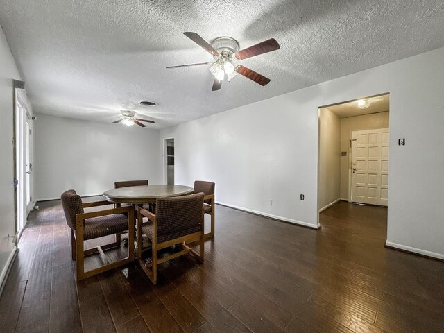 dining space with ceiling fan, a textured ceiling, and dark hardwood / wood-style flooring