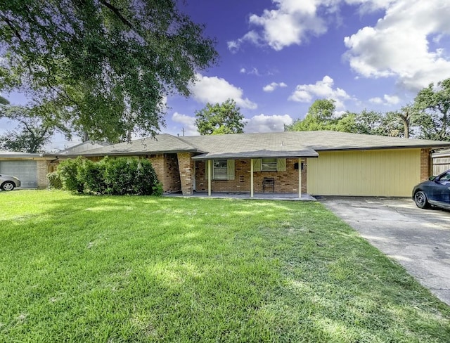 ranch-style house with a front yard, brick siding, and driveway