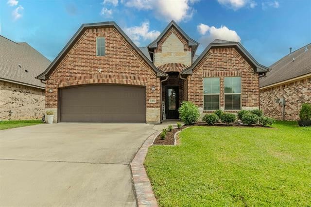 view of front of home with a garage and a front yard