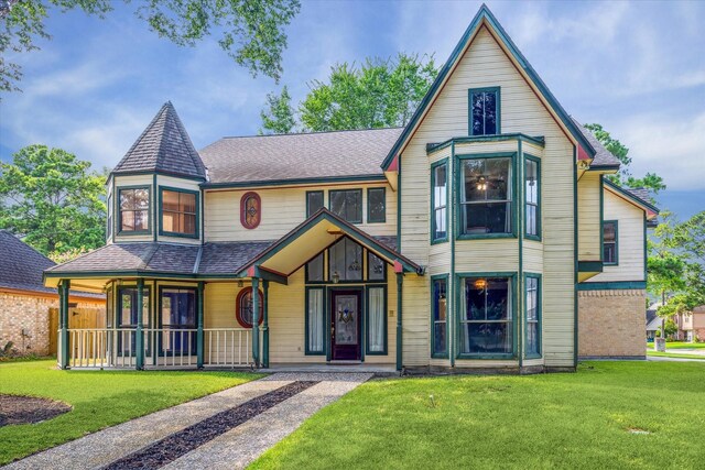 victorian-style house with a front yard