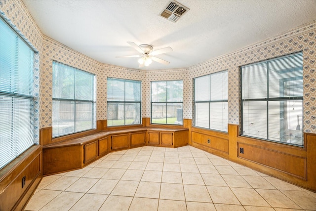 unfurnished sunroom with ceiling fan and visible vents