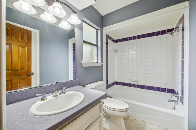 full bathroom with vanity, toilet, tiled shower / bath, and tile patterned flooring