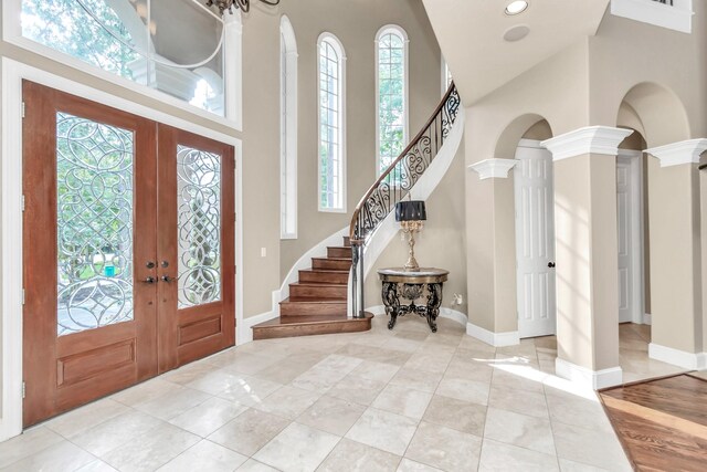 foyer featuring a healthy amount of sunlight, french doors, and hardwood / wood-style floors