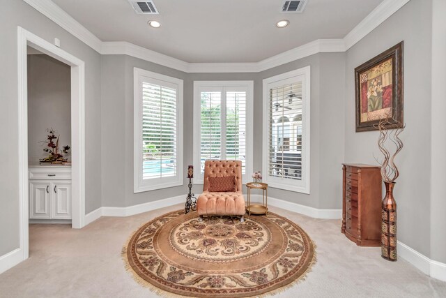 living area with light colored carpet and crown molding