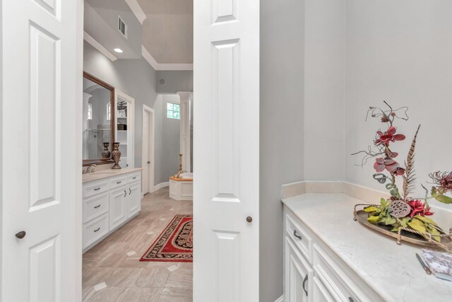 bathroom featuring vanity, crown molding, and tile patterned flooring