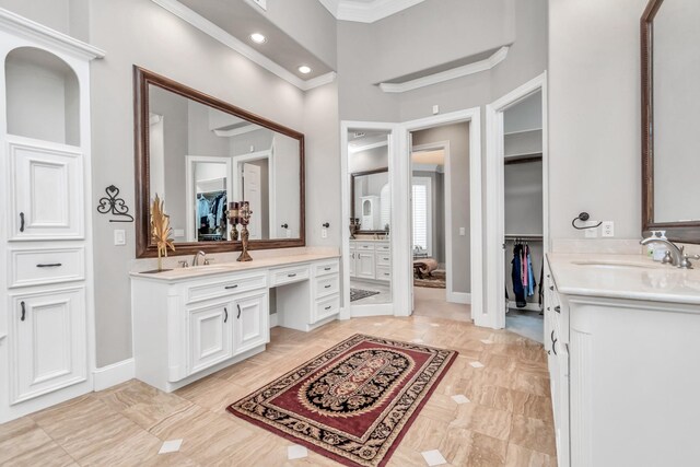 bathroom featuring crown molding, dual bowl vanity, tile patterned floors, and a towering ceiling