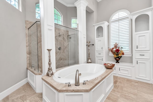 bathroom with ornamental molding, separate shower and tub, a wealth of natural light, and tile patterned flooring