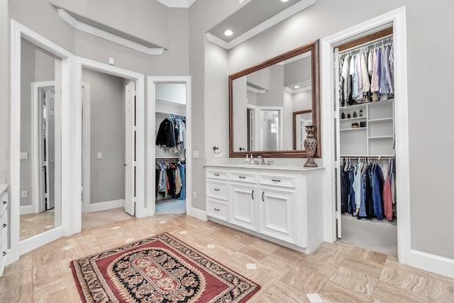 bathroom featuring vanity, ornamental molding, and tile patterned floors