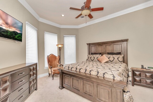 carpeted bedroom featuring ceiling fan and ornamental molding