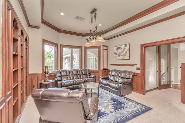 living room featuring ornamental molding and light carpet