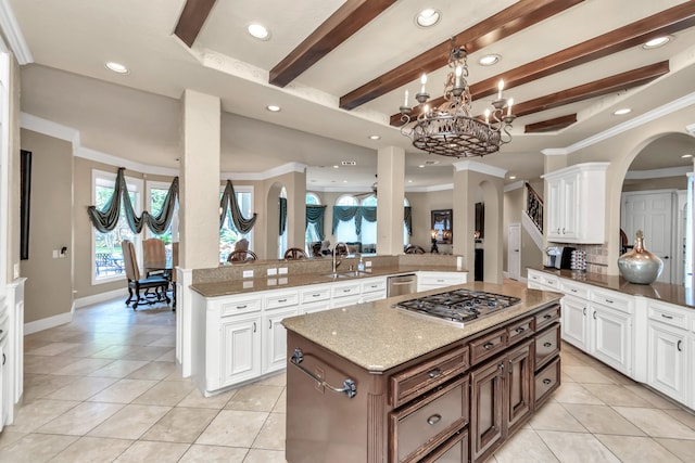 kitchen with white cabinetry, kitchen peninsula, a center island, beamed ceiling, and appliances with stainless steel finishes