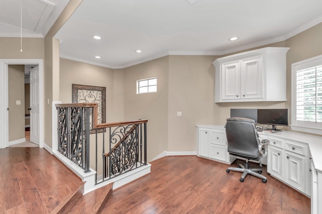 office space with ornamental molding, hardwood / wood-style floors, and built in desk