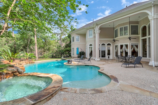 view of pool with an in ground hot tub, french doors, ceiling fan, and a patio area