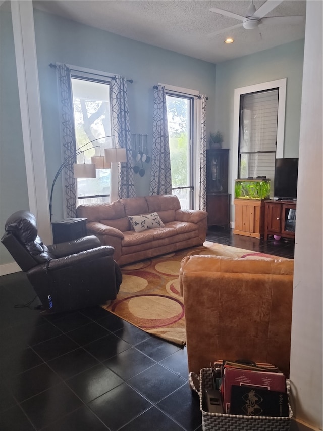 tiled living room featuring a textured ceiling and ceiling fan