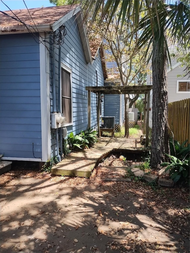 view of side of home with a patio and fence